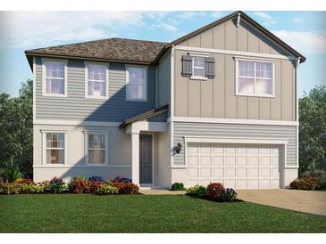 Charming two-story home featuring mixed siding, a two-car garage, and a professionally landscaped front yard at 3113 Legends Preserve Dr, Daytona Beach, FL 32124