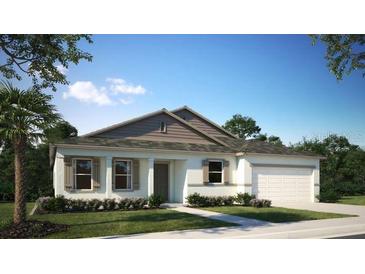 Charming single-story home featuring a two-car garage, neutral color palette and well-maintained landscaping at 345 S Sunset Ave, Mascotte, FL 34753