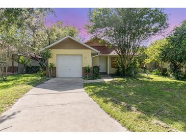 Charming single Gathering home featuring a one car garage and well maintained lawn with mature trees at 1007 Glendale St, Orlando, FL 32807