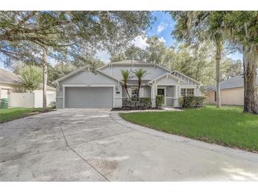 Charming one-story home with a well-manicured front yard and an attached two-car garage at 1307 Pup Fish Ln, Deland, FL 32724