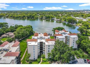 Beautiful lakefront condo building with lush green landscaping and stunning views from every unit at 204 Quayside Cir # 601, Maitland, FL 32751
