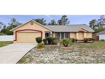 Charming single-story home with well-manicured landscaping and a two-car garage at 2741 Beaver Dr, Deltona, FL 32725
