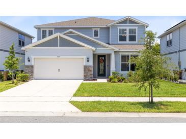 Charming two-story home with a well-manicured lawn and a two-car garage in a Gathering-friendly neighborhood at 5677 Cedar Chase Dr, St Cloud, FL 34771