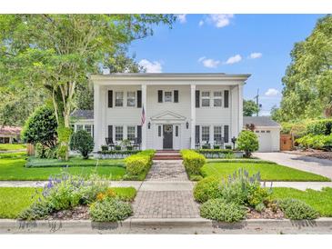 Classic colonial home featuring a manicured lawn, brick pathway, and stately white columns for curb appeal at 624 Richmond Street, Orlando, FL 32806