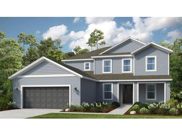 Charming two-story home with attached two-car garage, landscaped front yard, and a covered front entryway at 862 Junonia Blvd, New Smyrna Beach, FL 32168