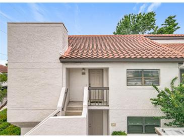 Charming condo featuring a red tile roof, white exterior, and well-maintained facade at 260 Killarney Bay Ct # 6-6, Winter Park, FL 32789
