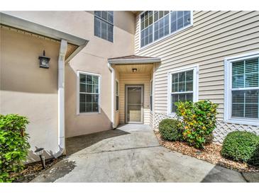 Inviting front entrance features a cozy covered porch and well-maintained landscaping at 3030 Clubview Dr # Ge, Orlando, FL 32822