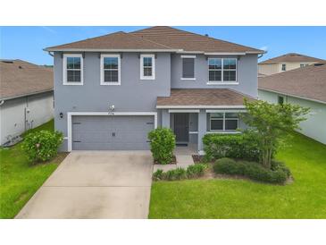 Charming two-story home featuring a gray exterior, well-maintained landscaping, and attached two-car garage at 3975 Silverstream Ter, Sanford, FL 32771