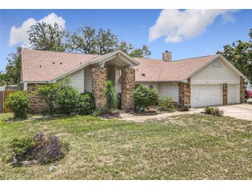 Charming single-story home with brick accents and mature landscaping in a quiet residential neighborhood at 6970 Knightswood Dr, Orlando, FL 32818