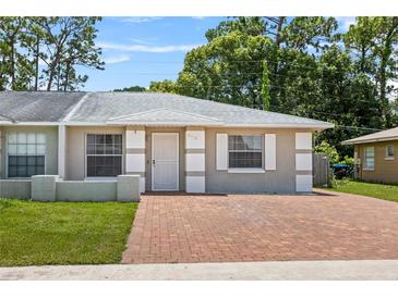 Charming single-story home featuring a well-maintained lawn and inviting brick driveway at 8116 Parrot Dr, Orlando, FL 32825