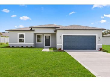 Charming single-story home with a well-manicured lawn and a two-car garage at 14905 Sw 39Th Cir, Ocala, FL 34473