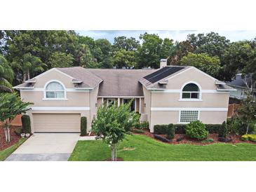 Charming two-story home featuring a well-manicured lawn and attached two car garage at 1653 Cheyenne Trl, Maitland, FL 32751