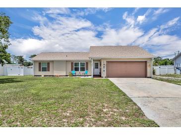 Charming single-story home featuring a well-maintained lawn and an attached two-car garage at 3043 Mapleshade St, Deltona, FL 32738