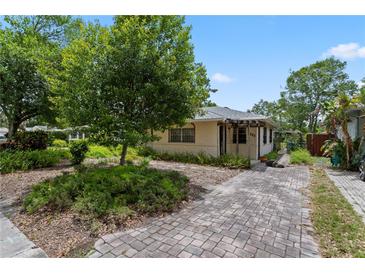 Charming home featuring a stone-paved driveway, lush landscaping, and a welcoming entrance at 3223 N Orange Ave, Orlando, FL 32803