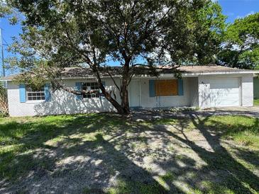 Charming single-story home with white painted brick and blue shutters at 4534 Lemans Dr, Orlando, FL 32808