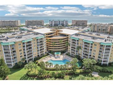 Expansive aerial view of a luxury condo complex with a central pool and ocean view at 4650 Links Village Dr # B103, Ponce Inlet, FL 32127