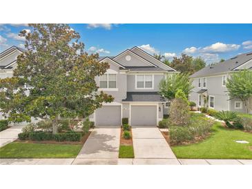 Beautiful two-story townhome with manicured landscaping and two-car garage at 976 Rock Harbor Ave, Orlando, FL 32828