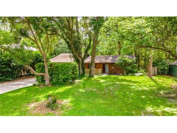 Charming single-story home nestled in lush greenery with a well-maintained lawn and cozy curb appeal at 109 Poinciana Ln, Deltona, FL 32738