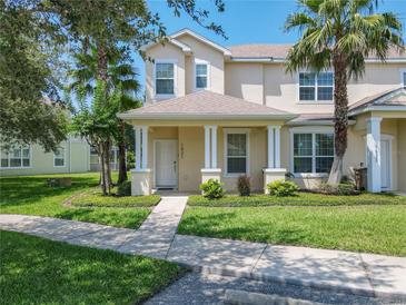 Charming two-story home with a well-manicured lawn and inviting front porch at 1521 Tranquil Ave, Clermont, FL 34714