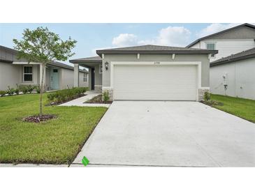 Charming single-story home with a two-car garage and a well-manicured lawn at 2778 Virginia Pine Dr, Bartow, FL 33830