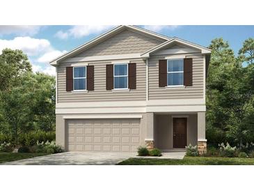 Charming two-story home featuring neutral siding, a two-car garage, and decorative shutters at 619 Wayland Dr, Haines City, FL 33844