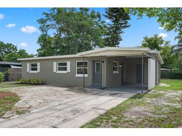 Charming single story home featuring neutral paint, white trim, and a covered carport at 709 Suzette Dr, Ocoee, FL 34761
