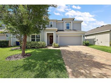 Charming two-story home featuring a spacious driveway and well-maintained landscaping at 1292 Cavender Creek Rd, Minneola, FL 34715