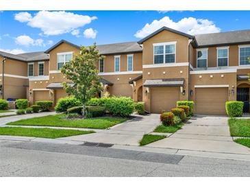 Attractive townhomes feature attached garages, neutral exteriors, landscaping and individual driveways at 2508 Seven Oaks Dr, St Cloud, FL 34772