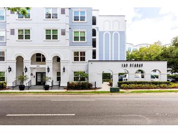 Beautiful exterior of The Grande, featuring manicured landscaping and covered entry at 300 E South St # 6016, Orlando, FL 32801