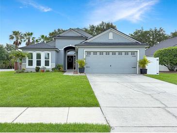 Charming single-story home with a well-manicured lawn, a two-car garage, and tasteful landscaping at 3101 Linton Rd, Kissimmee, FL 34758