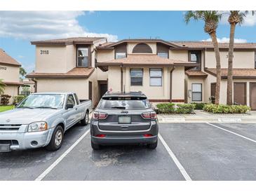Exterior of two story condo with visible reserved parking spaces in front at 3118 S Semoran Blvd # 2, Orlando, FL 32822