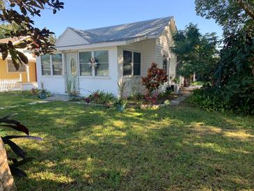 Charming single-story home with white siding and a well-manicured front lawn at 421 Ohio Ave, St Cloud, FL 34769