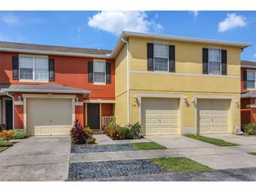 Inviting townhome featuring colorful exteriors, attached garages, and well maintained landscaping at 509 Cresting Oak Cir # 73, Orlando, FL 32824