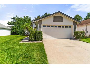Charming home with a well-manicured lawn and a two-car garage, perfect for suburban living at 5703 Arnold Zlotoff Dr, Orlando, FL 32821