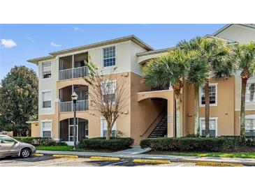 Multi-level condo building with beige exterior, palm trees, screened patios and convenient parking at 6214 Stevenson Dr # 208, Orlando, FL 32835