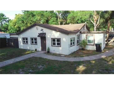 Charming single-story home with stucco exterior, brick walkway, and lush landscaping at 2515 Marlboro St, Orlando, FL 32806