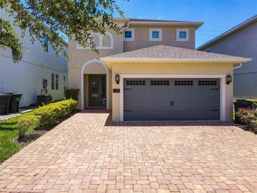 Charming two-story home featuring a paver driveway and a two-car garage at 370 Pendant Ct, Kissimmee, FL 34747