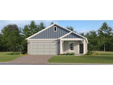 Charming single-Gathering home with a blue and grey exterior and a well-manicured lawn at 4548 Ochos Rios Pl, Kissimmee, FL 34758