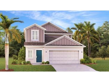 Charming two-story home boasts a welcoming blue front door, well-manicured lawn, and attached two-car garage at 5687 Portico Pl, Kissimmee, FL 34758