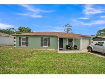 Charming one-story home with a well-maintained lawn and attached one-car garage at 6401 Fortune Ln, Apopka, FL 32712
