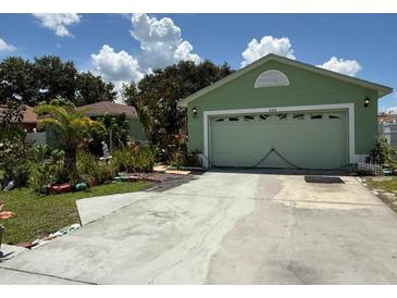 Charming single-Gathering home with a well-maintained lawn and driveway leading to an attached garage at 665 Regency Way, Kissimmee, FL 34758