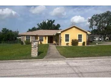 Charming single-story home features a well-manicured lawn, welcoming walkway, and inviting curb appeal at 705 N 6Th St, Haines City, FL 33844