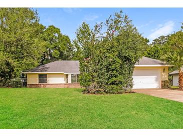 Charming single story home with a well-manicured lawn and mature trees at 10448 Sw 74Th Ct, Ocala, FL 34476