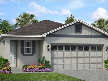 Charming single-story home with a two-car garage, neutral paint, a well-manicured lawn and a garden bed with purple flowers at 1210 Atlantic Ave, Fruitland Park, FL 34731