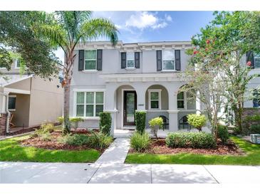 Charming two-story home with landscaped yard and covered front porch, perfect for enjoying the outdoors at 14460 Orchard Hills Blvd, Winter Garden, FL 34787