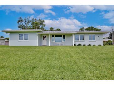 Charming single-story home featuring a well-manicured lawn and appealing architectural design at 216 N Riverside Dr, Edgewater, FL 32132