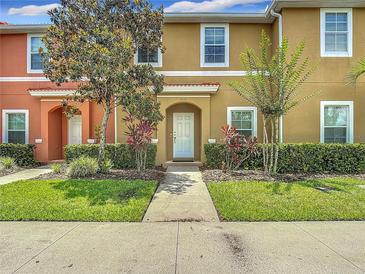 Charming multi-colored townhome featuring manicured landscaping and a welcoming entrance at 3010 Secret Lake Dr, Kissimmee, FL 34747