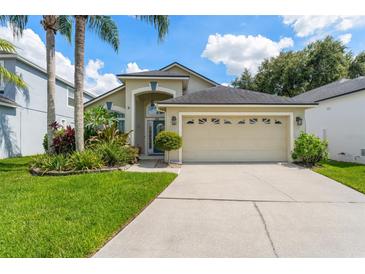 Charming single-Gathering home featuring a two-car garage and well-manicured landscaping at 462 Lakepark Trl, Oviedo, FL 32765