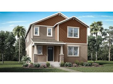 Charming two-story home with brown siding, landscaped yard, and a welcoming front porch at 504 Green Tracker Ave, Clermont, FL 34715