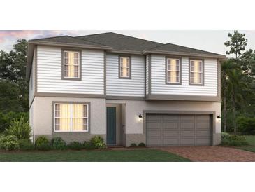 Two-story home with a two-car garage, gray roof, and neutral color palette at 5928 Ali Grace Dr, St Cloud, FL 34771